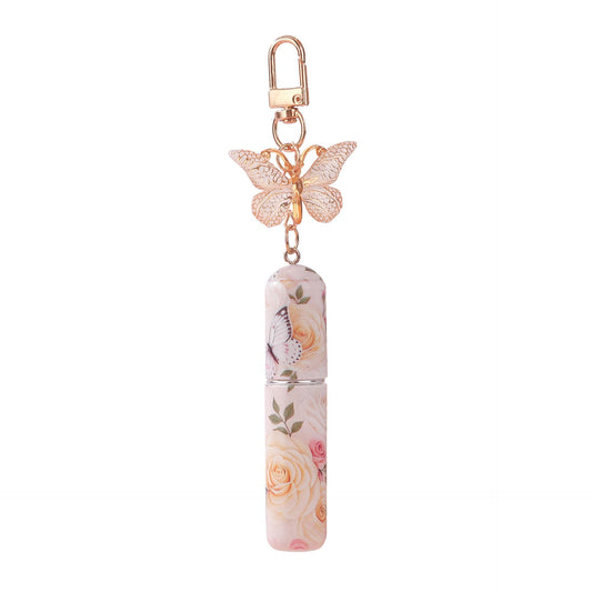 Refillable perfume atomizer keychain with pink butterfly charm and floral spray bottle