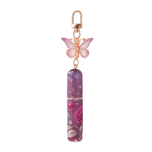 Perfume atomizer keychain with butterfly charm and purple floral refill bottle
