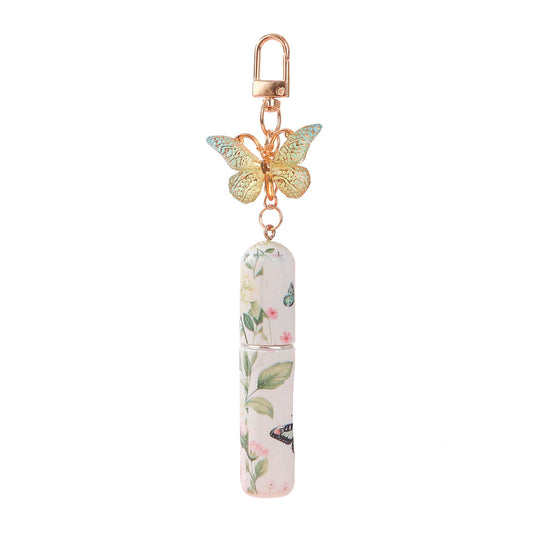 Floral refillable perfume atomizer keychain with butterfly charm and light pink bottle