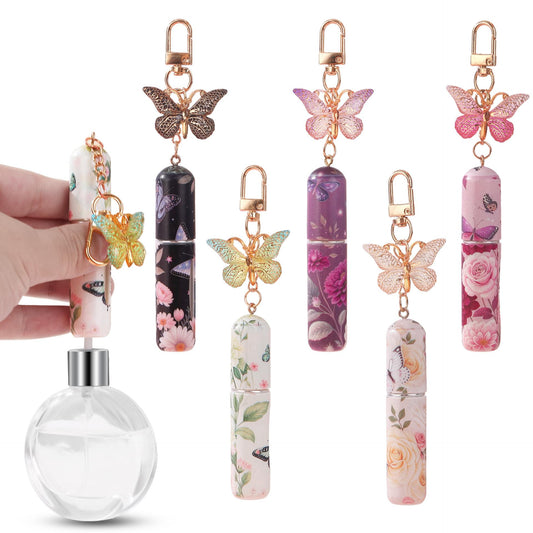 Set of floral perfume atomizer keychains with butterfly charms and small spray bottles