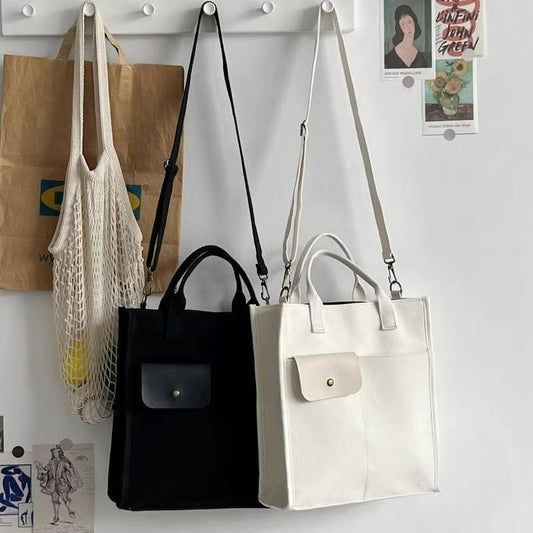 White canvas tote bag with front pocket and adjustable long crossbody strap