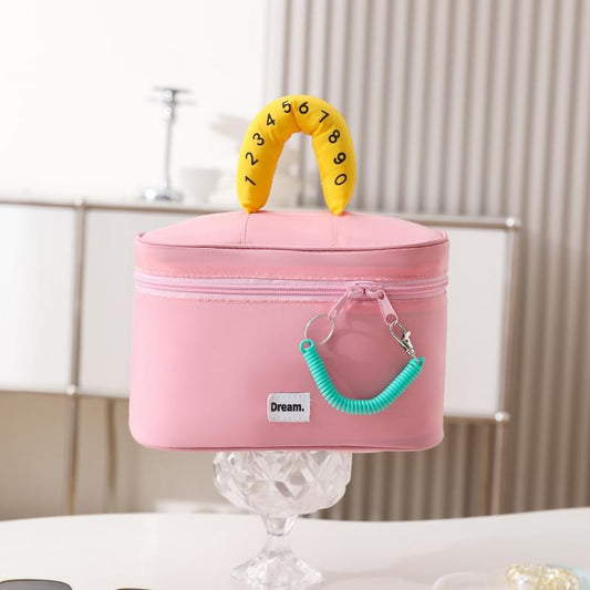 Pink large cosmetic bag with zipped top and yellow U-shaped handle, teal rope charm