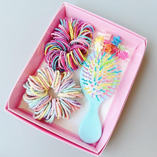 Pink boxed hair tie set with multicolor scrunchies and blue mini comb