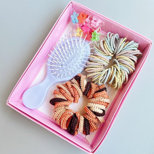 Hair tie set in pink box with striped spiral hair ties, mini comb, and brush