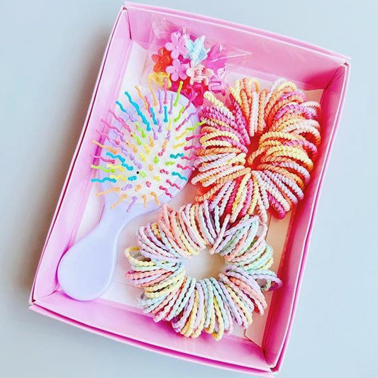 Boxed hair tie set with rainbow spiral bands and white mini comb in pink tray
