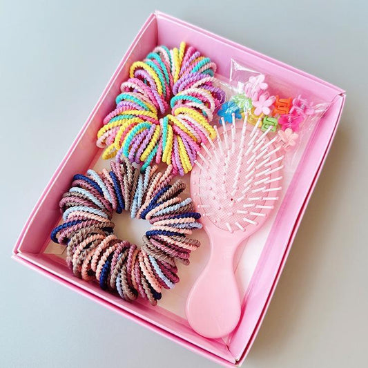 Pink boxed hair tie set with rainbow spiral ties and a mini comb