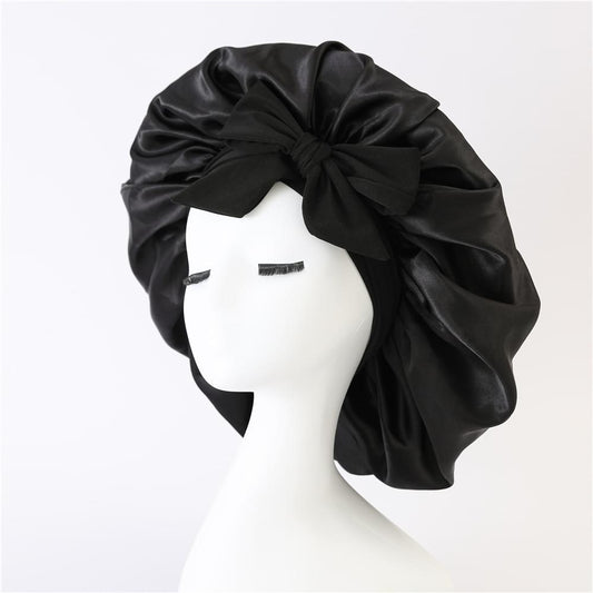 Black satin bonnet with wide band and bow tie, gathered crown and wrap style