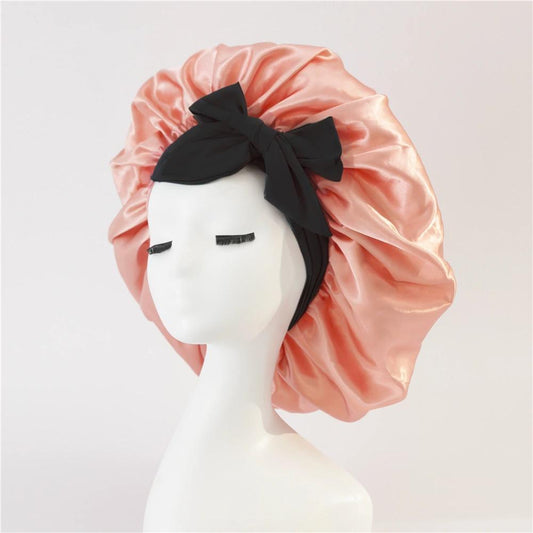 Rose pink satin hair bonnet with black wide band and bow tie, gathered ruffle edge