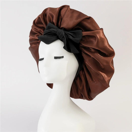 Brown satin sleep bonnet with wide band and black bow on head profile