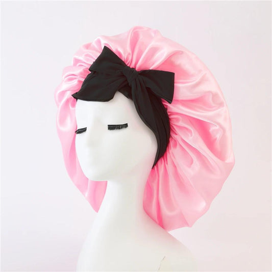 Pink satin sleep bonnet with wide black band and large bow tie