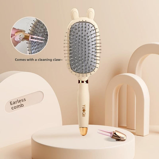 Hair detangling brush with rabbit-ear cushion, cream handle and grey pin pad