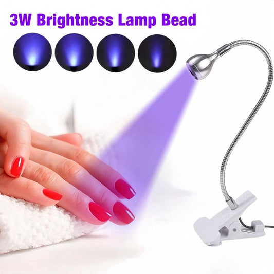Black UV LED lamp head with flexible gooseneck clip, aimed at manicured nails