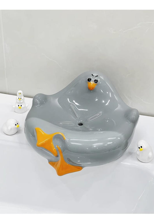 Grey ceramic seagull soap dish with drainage, cartoon bird shape and orange beak