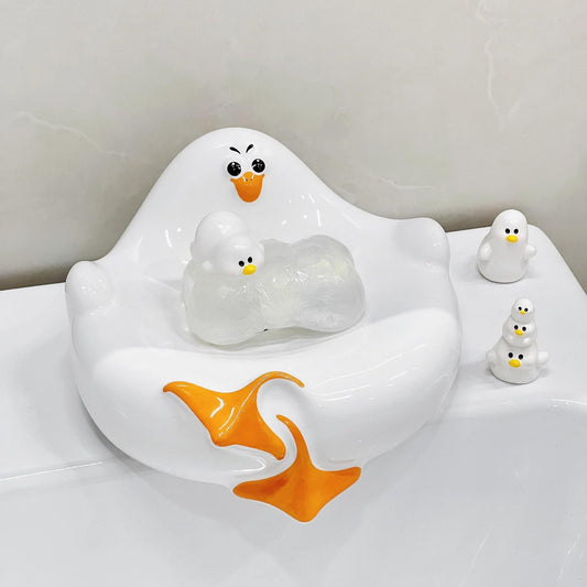 White ceramic seagull soap dish with drainage groove, holding a soap bar