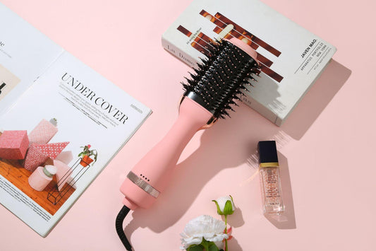 Pink hot air hair brush dryer with round vented comb barrel and black power cord