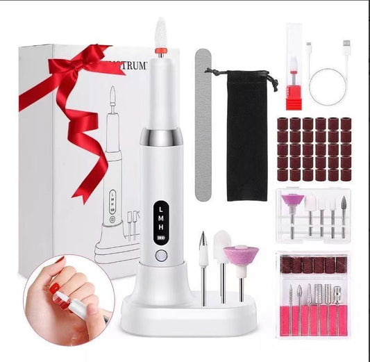 Cordless electric nail drill kit with white charging base and assorted sanding bits