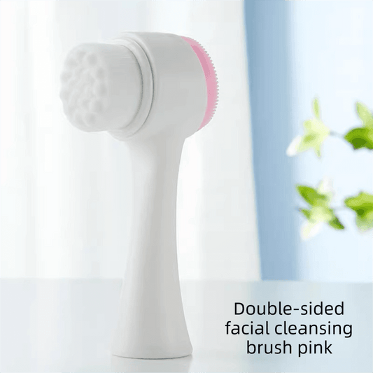 Dual-sided facial cleansing brush with pink silicone scrub pad and white handle