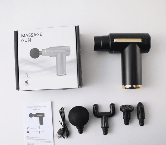 Black massage gun with gold accent and four interchangeable head attachments