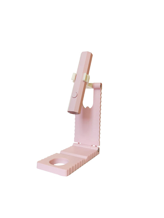 Pink mini handheld LED/UV manicure light with fixed stand and cradle base