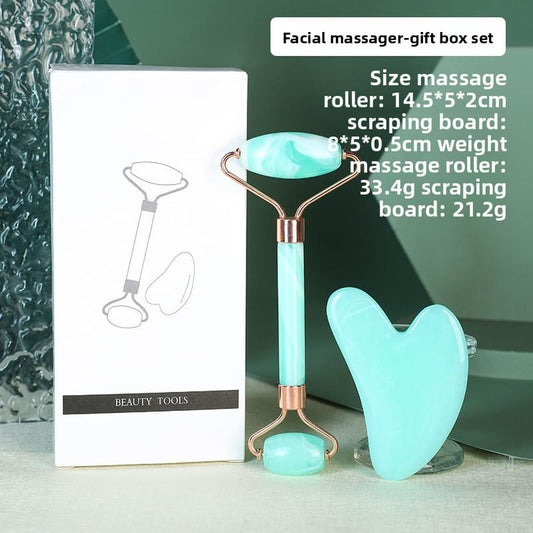 Teal resin facial roller and heart-shaped gua sha set with gold-toned handles