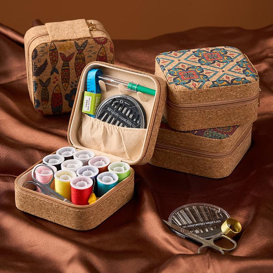 Portable sewing kit organizer open with thread spools, tools, and scissors