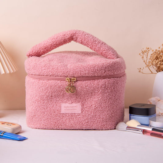 Pink plush teddy fleece cosmetic bag with handle, top zipper and gold charm clip