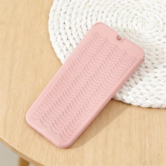 Pink silicone wave anti-scalding mat with wavy ridges and hanging loop