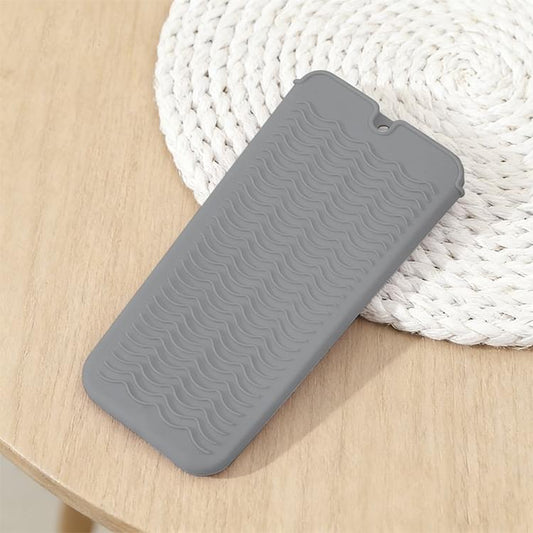 Grey silicone wave heat-resistant mat with scalloped ridges and hanging hole