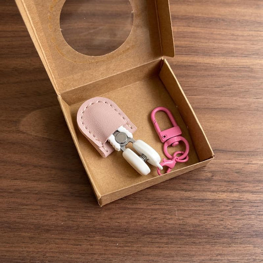 Mini precision scissors set with pink safety cap and leather sheath in kraft box
