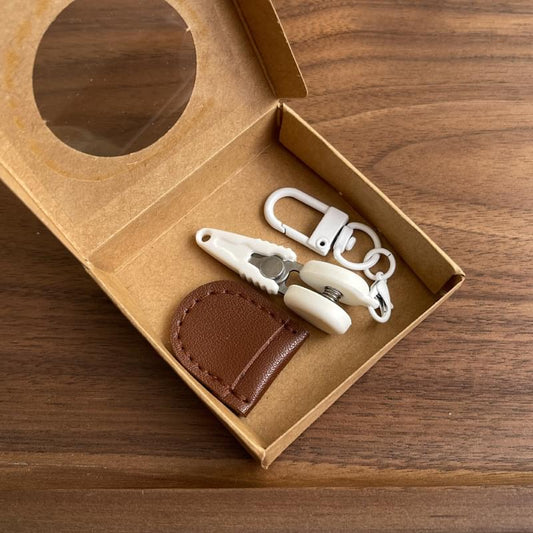 Mini precision scissors set with safety cap and brown leather sheath in open box