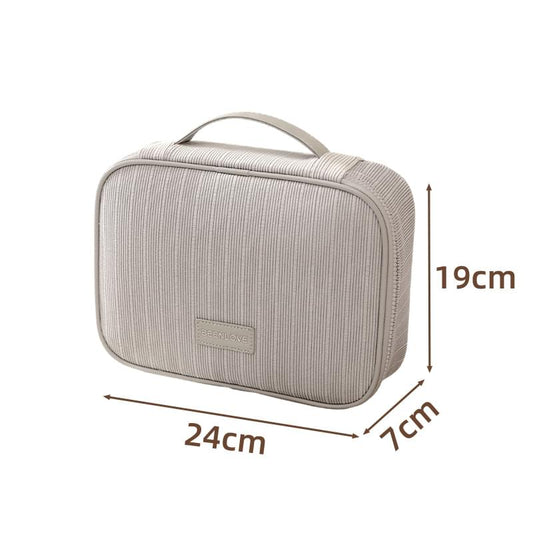 Large travel makeup bag in light gray striped fabric with top handle and zipper front panel