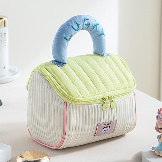 Quilted cosmetic bag, light green lid, white stripes, and zipper trim