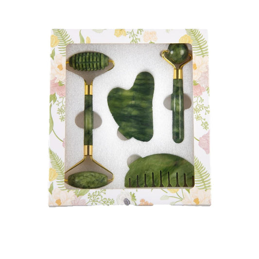 Green jade facial roller and gua sha set with comb tools, presented in a box.