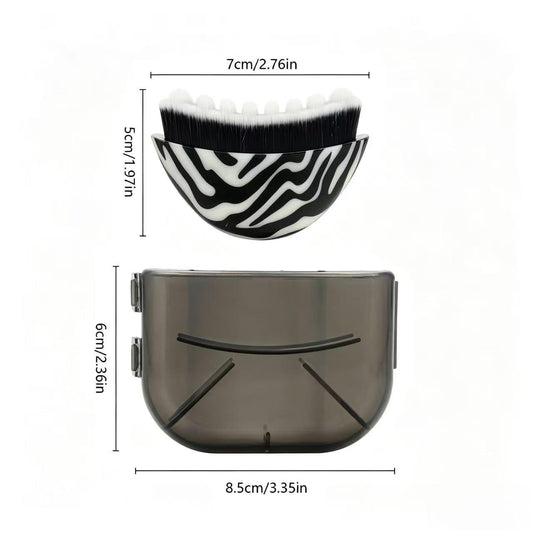Curved zebra-print facial massage brush with white and black bristles, plastic handle