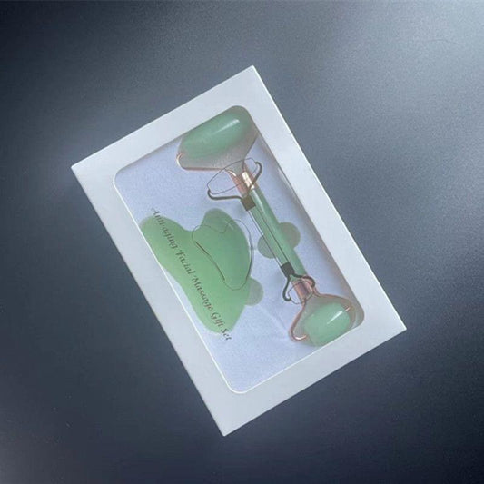 Green stone gua sha facial tool with loop handle, in white box