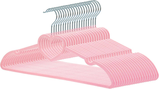 Pink velvet clothes hanger with heart cutout and smooth rounded shoulders