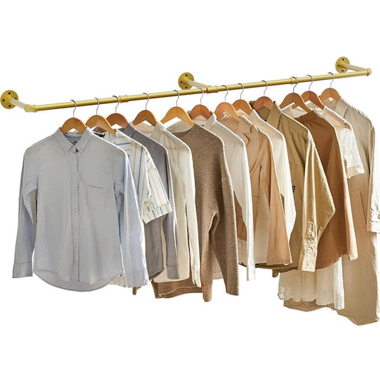 Gold wall-mounted clothes rail with shirts and jackets hanging on wooden hangers