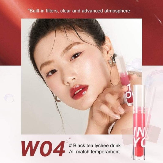 Lip gloss shade W04 on lips and tube, coral-red watery gloss with clear applicator