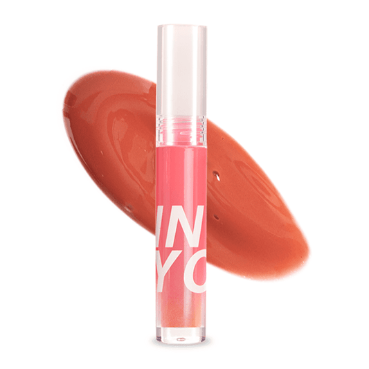Watery mist lip gloss in a coral-red shade, clear tube with pink cap and wand