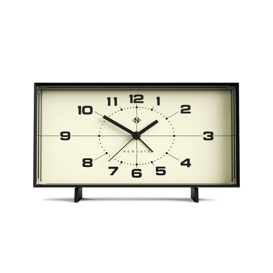 Black rectangular alarm clock with cream dial, bold numerals, analog hands on stand