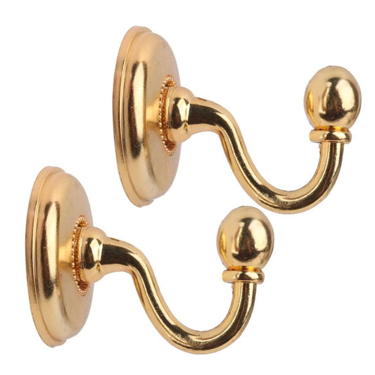 Gold metal curtain holdback wall hooks with curved arms and ball finials