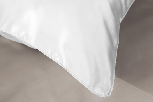 White silk pillowcase corner with angled seam and folded flap