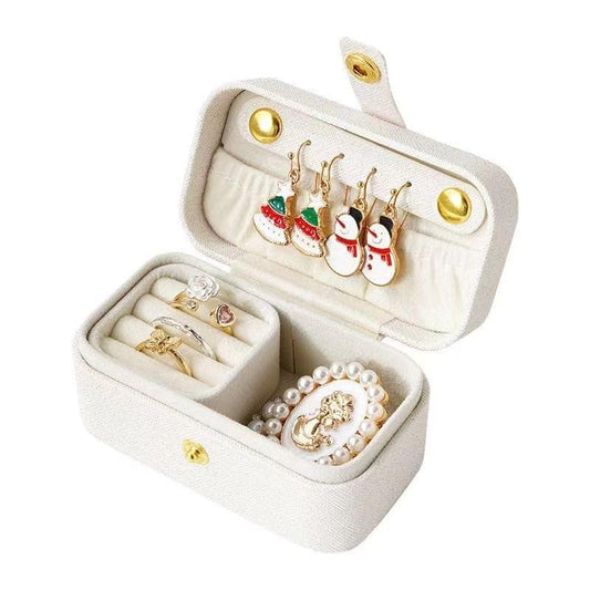 White jewelry travel case open with ring tray and earring slots, gold hardware