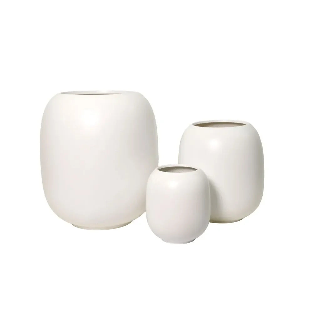 White ceramic vase set of three with rounded bodies and open tops