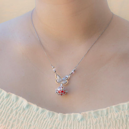 Silver-tone butterfly necklace with red heart locket diffuser and small dangling charm