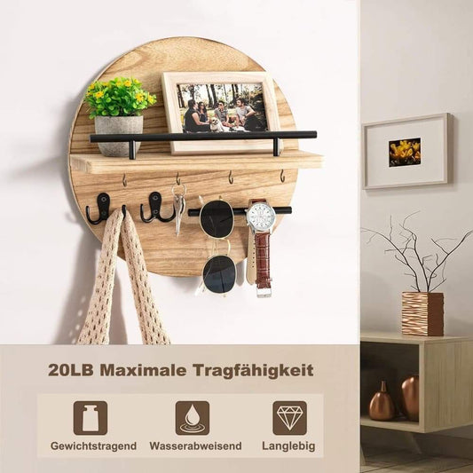 Round wall key holder with light brown wood shelf and multiple metal hooks