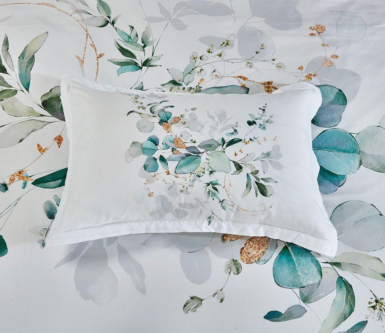 Pillowcase and duvet cover with white botanical print and teal eucalyptus leaves