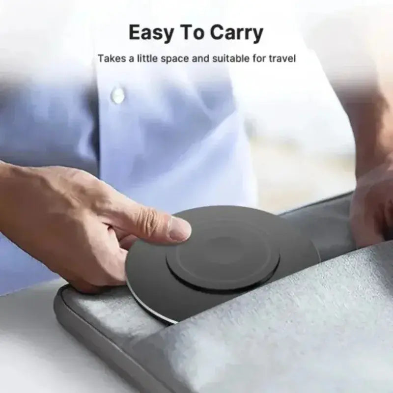 Black wireless charging pad with centered disc, placed on a surface.