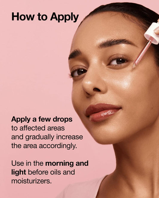 Serum dropper applying clear serum to cheek area, with a thin applicator tool