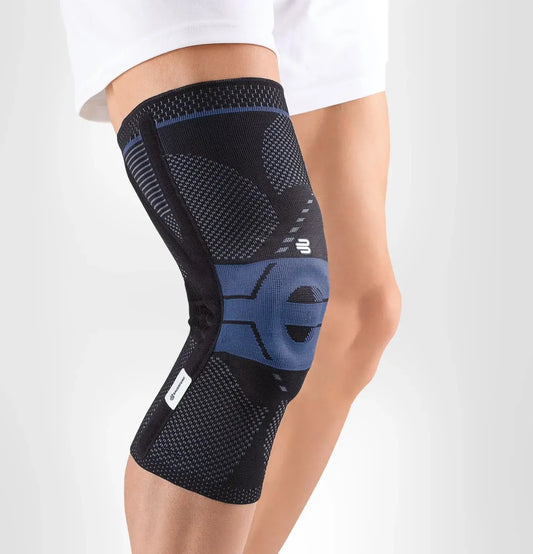 Knee support brace in dark knit with blue accents and hinged stabilizer, worn on leg